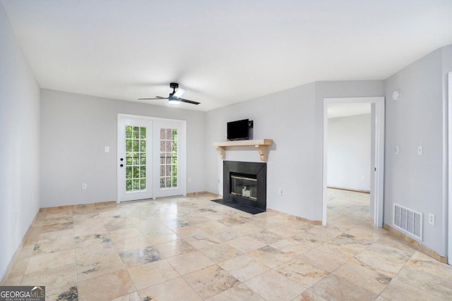 unfurnished living room featuring ceiling fan and light tile patterned flooring