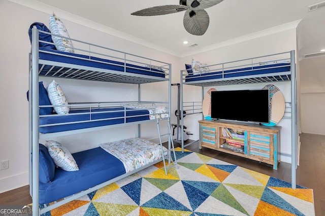 bedroom with visible vents, wood finished floors, recessed lighting, crown molding, and baseboards