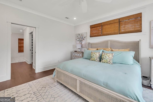 bedroom with visible vents, baseboards, ornamental molding, recessed lighting, and wood finished floors