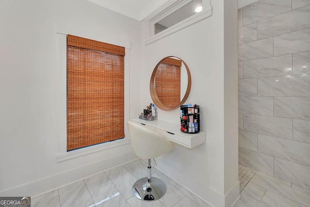 bathroom with baseboards and a tile shower