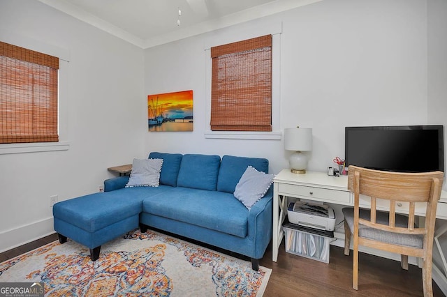 living room with baseboards, wood finished floors, and crown molding