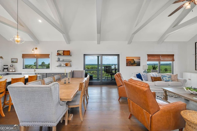 dining area with beamed ceiling, a healthy amount of sunlight, high vaulted ceiling, and wood finished floors