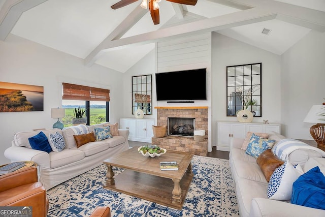 living area featuring wood finished floors, visible vents, high vaulted ceiling, a fireplace, and beamed ceiling