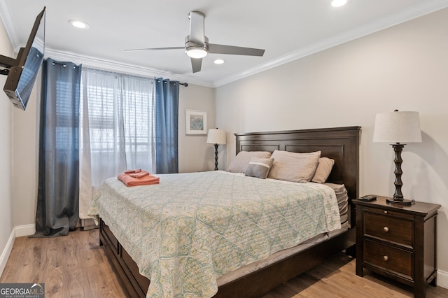 bedroom with light hardwood / wood-style flooring, ceiling fan, and ornamental molding