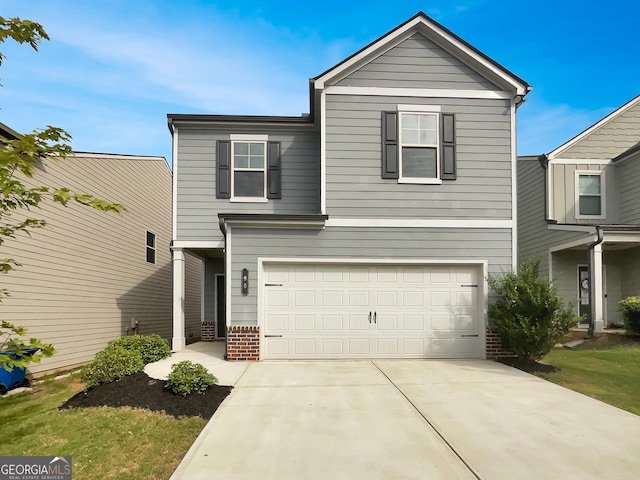 traditional-style home featuring a garage, concrete driveway, and brick siding