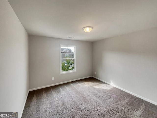 carpeted empty room with baseboards