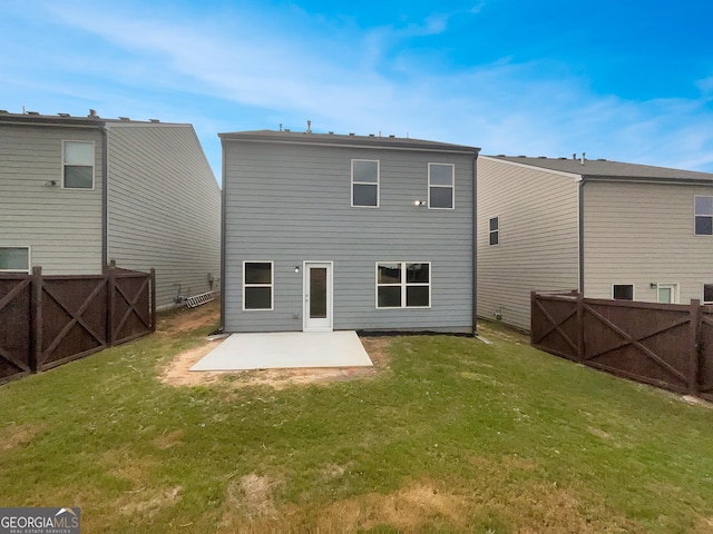 rear view of house with a yard, a fenced backyard, a gate, and a patio