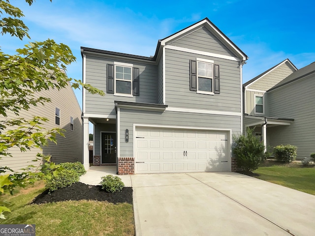 traditional-style home featuring a garage, concrete driveway, and brick siding