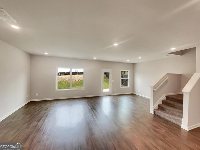 unfurnished living room featuring dark hardwood / wood-style floors