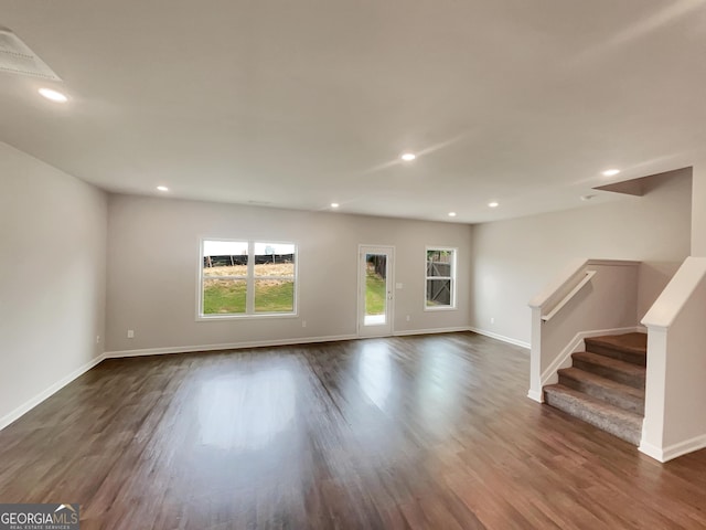 unfurnished living room with baseboards, dark wood finished floors, and recessed lighting