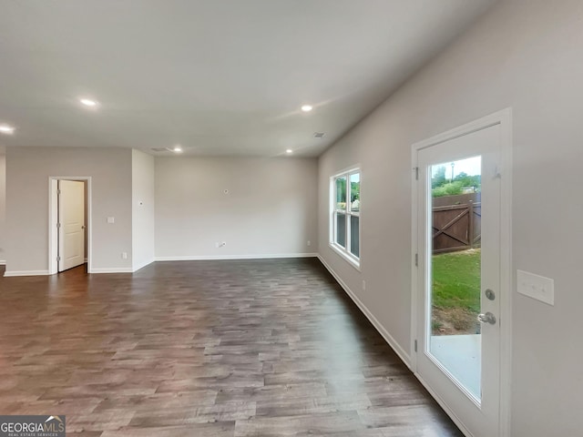 unfurnished living room with recessed lighting, visible vents, baseboards, and wood finished floors