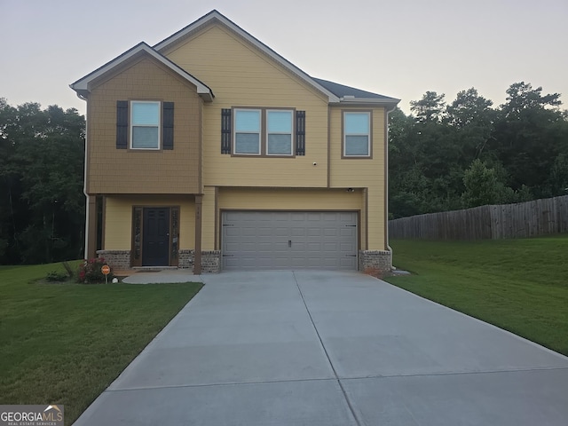 view of front of house featuring an attached garage, fence, a front lawn, and concrete driveway