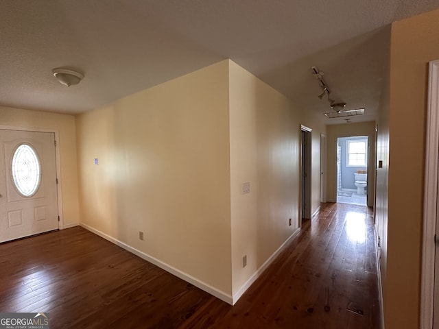 foyer featuring track lighting and wood-type flooring