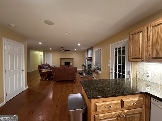 kitchen featuring ceiling fan, hardwood / wood-style flooring, tasteful backsplash, and white dishwasher