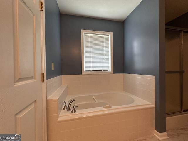 bathroom featuring a relaxing tiled tub