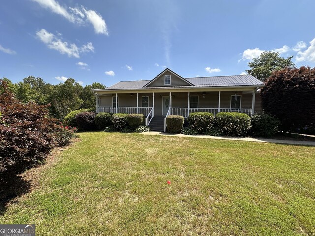 view of front of property with a front yard and covered porch