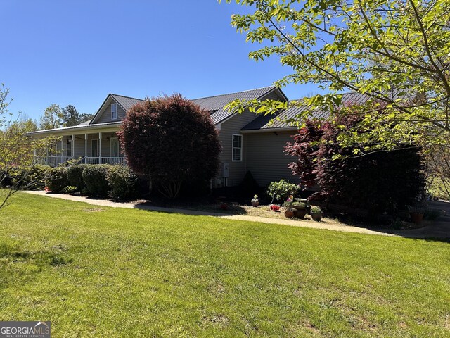 view of property exterior with a yard