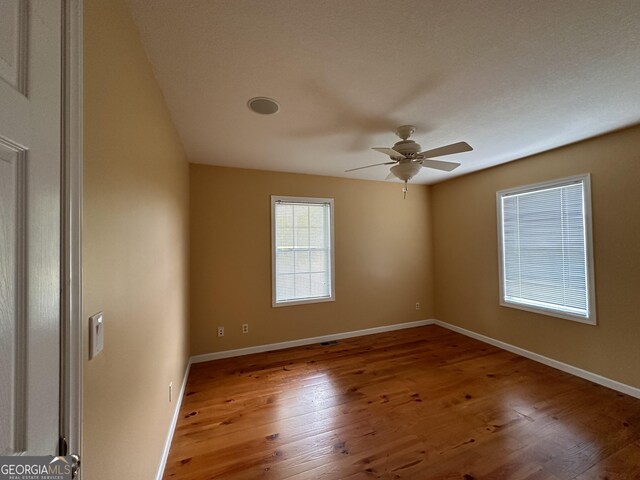 unfurnished room with ceiling fan and light hardwood / wood-style flooring