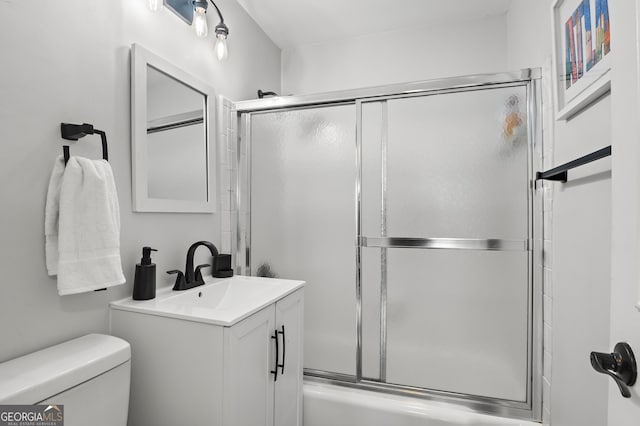 bathroom featuring shower / bath combination with glass door, vanity, and toilet