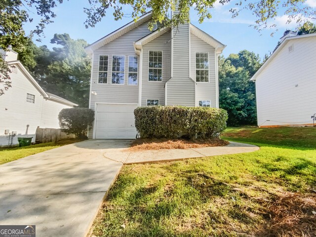 front facade featuring a garage and a front lawn