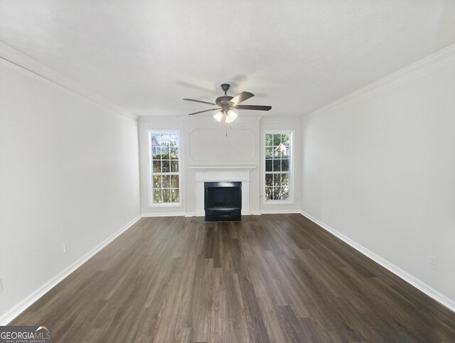 unfurnished living room with hardwood / wood-style floors, plenty of natural light, ornamental molding, and ceiling fan