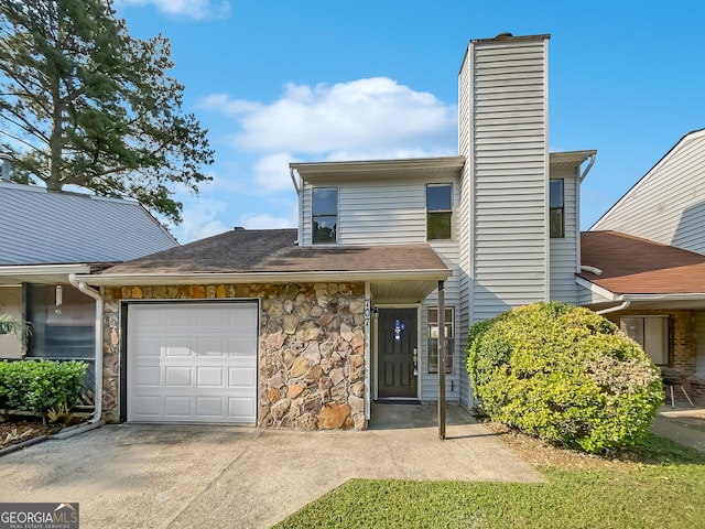 multi unit property with driveway, stone siding, a chimney, roof with shingles, and an attached garage