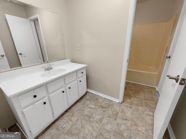 bathroom featuring baseboards and vanity