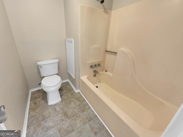 full bathroom with baseboards, shower / bath combination, and toilet