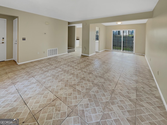 empty room featuring visible vents and baseboards