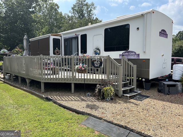 back of property featuring a wooden deck