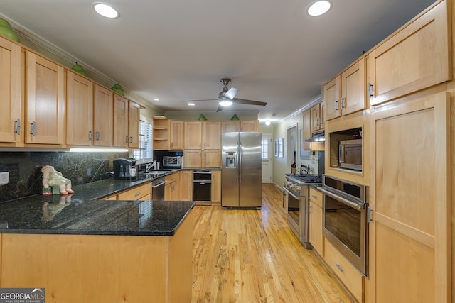 kitchen with light hardwood / wood-style flooring, decorative backsplash, light brown cabinets, ceiling fan, and stainless steel appliances