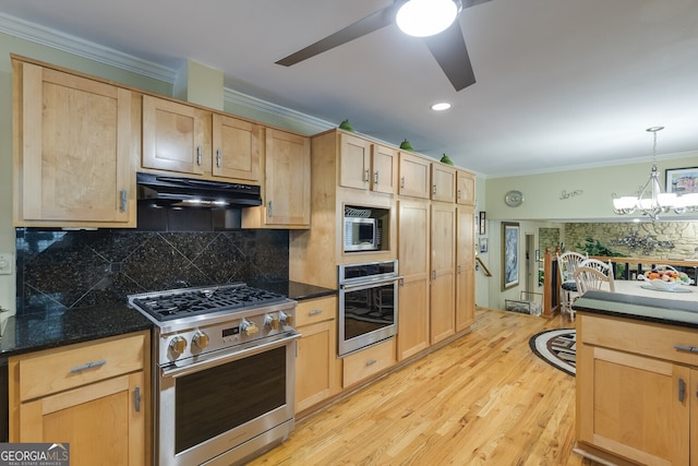 kitchen with light wood-type flooring, decorative backsplash, light brown cabinetry, ceiling fan with notable chandelier, and stainless steel appliances