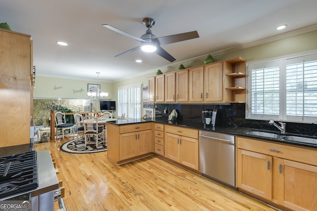 kitchen featuring kitchen peninsula, stainless steel dishwasher, backsplash, and a healthy amount of sunlight