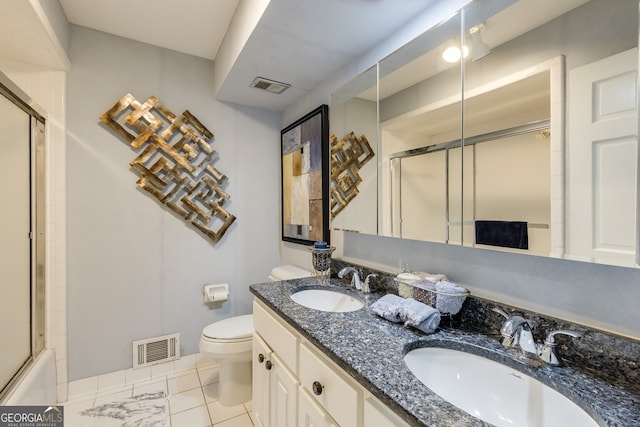 full bathroom featuring tile patterned floors, double vanity, shower / bath combination with glass door, and toilet