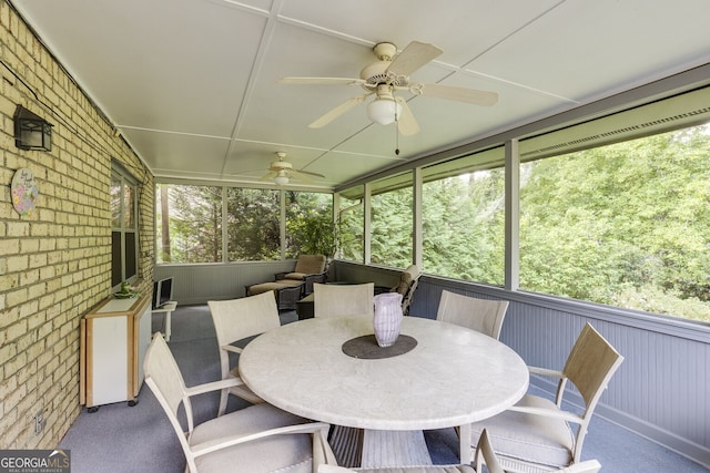 sunroom featuring ceiling fan