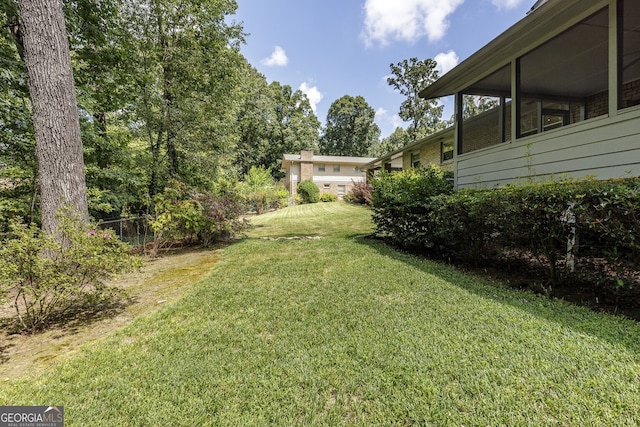 view of yard featuring a sunroom