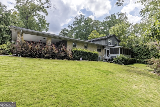 view of front of property with a front yard and a sunroom