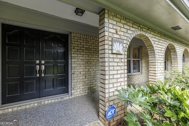 doorway to property featuring covered porch