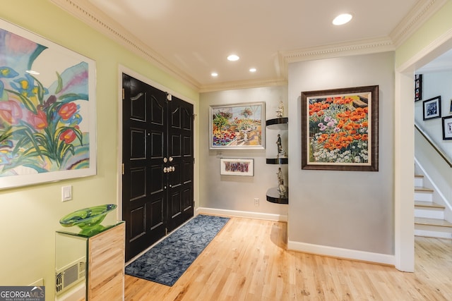 entrance foyer featuring hardwood / wood-style flooring and ornamental molding