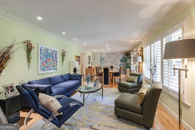 living room with light hardwood / wood-style flooring and ornamental molding