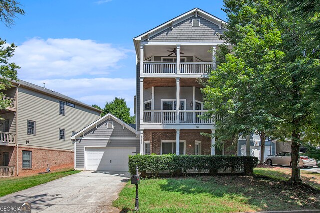 view of front of home featuring ceiling fan, a front lawn, a garage, and a balcony