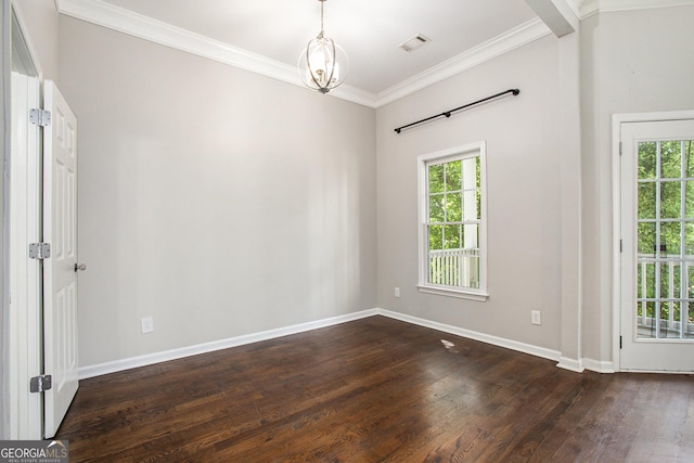 unfurnished room featuring dark wood-type flooring, crown molding, a wealth of natural light, and an inviting chandelier
