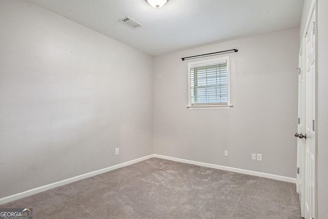 empty room featuring light carpet