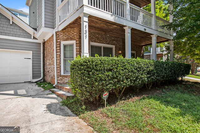 view of side of home with a balcony and a garage