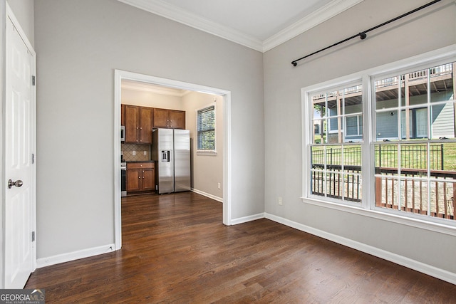 unfurnished dining area featuring dark hardwood / wood-style floors and ornamental molding