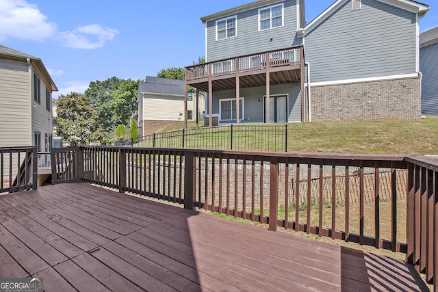 wooden terrace featuring a lawn
