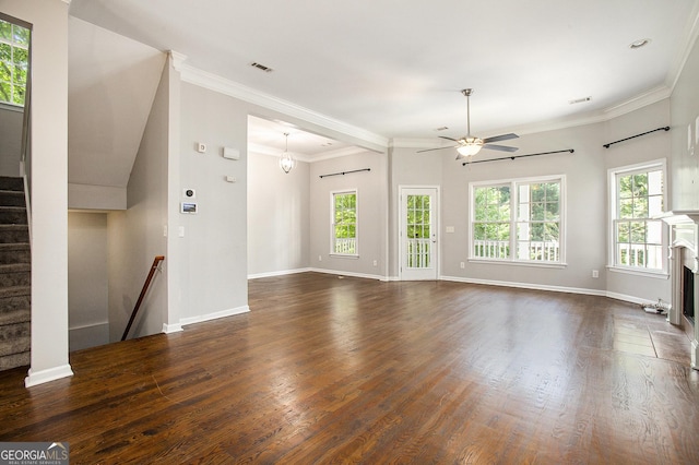 unfurnished living room featuring ornamental molding, dark hardwood / wood-style floors, and a wealth of natural light