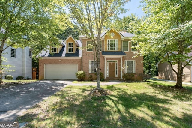 view of front of house with a front lawn and a garage