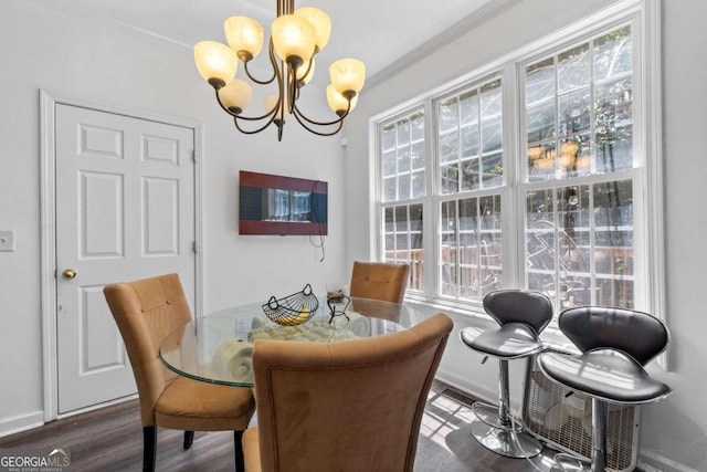 dining space with a notable chandelier, crown molding, and hardwood / wood-style floors