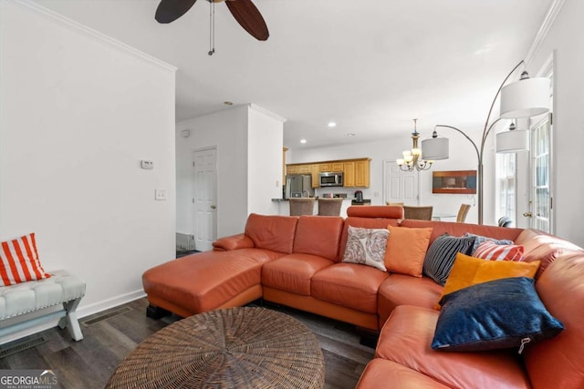 living room with crown molding, ceiling fan with notable chandelier, and dark hardwood / wood-style floors